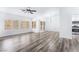 Open-concept living space with modern flooring and abundant natural light from large windows at 10041 Arbuckle Dr, Las Vegas, NV 89134