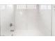 Bright shower-over-tub with elegant white marble style tiling with window letting in natural light at 10041 Arbuckle Dr, Las Vegas, NV 89134