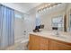 Bathroom featuring a vanity, mirror, shower and tub combo with a blue striped shower curtain at 10265 Franford Ct, Las Vegas, NV 89183