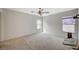 Spacious bedroom featuring a ceiling fan, carpet flooring, and natural light from dual windows at 10265 Franford Ct, Las Vegas, NV 89183