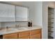 Eat-in kitchen featuring wood cabinets, a white countertop, and pantry with open shelving at 10265 Franford Ct, Las Vegas, NV 89183