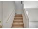 Carpeted staircase with white handrail leads to the upper level of the home at 10265 Franford Ct, Las Vegas, NV 89183