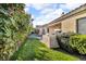 Landscaped backyard with green grass, built-in grill, patio furniture, and a hot tub at 10705 Arundel Ave, Las Vegas, NV 89135
