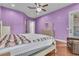 Bedroom showcasing a cozy bed, an open doorway, and a private patio access to outdoor space at 10705 Arundel Ave, Las Vegas, NV 89135