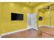Bright bedroom featuring a mirrored closet, a ceiling fan, and two TVs at 10705 Arundel Ave, Las Vegas, NV 89135