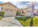 Lovely single-story home featuring a well-kept lawn, mature landscaping, and a three-car garage at 10705 Arundel Ave, Las Vegas, NV 89135