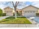 Charming single-story home with a well-manicured lawn and a three-car garage at 10705 Arundel Ave, Las Vegas, NV 89135