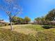 Well-maintained greenbelt with lush grass, mature trees, and community landscaping at 10705 Arundel Ave, Las Vegas, NV 89135