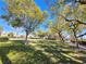 Community greenbelt with mature trees, lush grass, and walking paths at 10705 Arundel Ave, Las Vegas, NV 89135