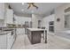 Modern kitchen features an island, stainless steel appliances, and white cabinets at 10705 Arundel Ave, Las Vegas, NV 89135