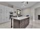 Island kitchen with white cabinets, stainless steel appliances, marble floors, and seating at 10705 Arundel Ave, Las Vegas, NV 89135