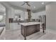 Bright kitchen featuring marble floors, an island, stainless steel appliances, and white cabinets at 10705 Arundel Ave, Las Vegas, NV 89135