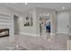 Spacious living room showcasing marble floors, fireplace, and open access to kitchen at 10705 Arundel Ave, Las Vegas, NV 89135