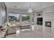 Bright living room with marble floors, a fireplace, and a large sectional couch at 10705 Arundel Ave, Las Vegas, NV 89135