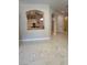 Bright living room featuring sleek marble floors and a view into the kitchen with modern appliances at 10705 Arundel Ave, Las Vegas, NV 89135