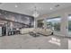 Spacious living room featuring a stylish chandelier, modern sectional, and a unique cityscape mural wall at 10705 Arundel Ave, Las Vegas, NV 89135