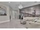 Large living room with marble floors, a modern chandelier, and a comfortable sectional sofa at 10705 Arundel Ave, Las Vegas, NV 89135