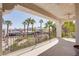 Large covered balcony with wrought iron railing offering community views and palm trees at 12 Cascade Lake St, Las Vegas, NV 89148