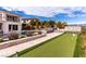 Backyard showcasing a pool, putting green, desert landscaping, and a serene outdoor space at 12 Olympia Chase Dr, Las Vegas, NV 89141