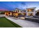 Luxury home featuring outdoor kitchen, swimming pool with fire features, and putting green against scenic mountain views at 12 Olympia Chase Dr, Las Vegas, NV 89141