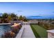 Expansive backyard with a pool, putting green, and a built-in fire pit, perfect for outdoor fun at 12 Olympia Chase Dr, Las Vegas, NV 89141