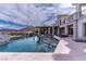 Stunning backyard with a large pool, outdoor kitchen, and comfortable seating area ideal for outdoor living at 12 Olympia Chase Dr, Las Vegas, NV 89141