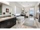 Bright bathroom with double sinks, bathtub and a view to the bedroom with outdoor view at 12 Olympia Chase Dr, Las Vegas, NV 89141