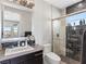 Modern bathroom features a sink, toilet, walk-in shower with glass doors and an outdoor view at 12 Olympia Chase Dr, Las Vegas, NV 89141