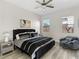 Stylish bedroom features a ceiling fan, windows providing natural light, and cozy seating area at 12 Olympia Chase Dr, Las Vegas, NV 89141
