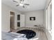 Bright bedroom featuring a ceiling fan, natural light from large windows, and sleek flooring at 12 Olympia Chase Dr, Las Vegas, NV 89141