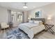 Bright bedroom features a large bed, stylish rug, modern decor, and neutral paint at 12 Olympia Chase Dr, Las Vegas, NV 89141