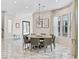 Elegant dining room with a round table, modern chandelier, and plenty of natural light at 12 Olympia Chase Dr, Las Vegas, NV 89141