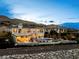 Stately two-story home featuring an outdoor kitchen, shimmering pool and spa with mountain views at 12 Olympia Chase Dr, Las Vegas, NV 89141