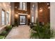 Charming front porch with a stone accent wall, comfortable seating, and elegant lighting perfect for relaxing outdoors at 12 Olympia Chase Dr, Las Vegas, NV 89141