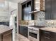 Modern kitchen with dark cabinetry, stainless steel appliances, stylish backsplash, and an open layout, ideal for entertaining at 12 Olympia Chase Dr, Las Vegas, NV 89141