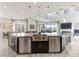Bright, open kitchen featuring stainless steel appliances, a large island, and marble floors at 12 Olympia Chase Dr, Las Vegas, NV 89141