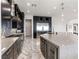 Modern kitchen with dark cabinetry, stainless steel appliances, sleek countertops, and wine fridge at 12 Olympia Chase Dr, Las Vegas, NV 89141