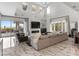 Bright and open living room with high ceilings, a large sofa, fireplace, and access to outdoor patio, perfect for relaxation at 12 Olympia Chase Dr, Las Vegas, NV 89141