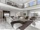 Large living area showcasing an open layout, marble floors, and second story balcony at 12 Olympia Chase Dr, Las Vegas, NV 89141
