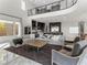 Bright living room featuring high ceilings, a comfortable seating area, and view to the kitchen at 12 Olympia Chase Dr, Las Vegas, NV 89141