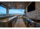 Beautiful covered outdoor kitchen with stainless steel appliances, bar seating, and views at 12 Olympia Chase Dr, Las Vegas, NV 89141