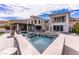 Inviting backyard pool and spa with stone decking and lush landscaping, perfect for relaxation and enjoying the outdoors at 12 Olympia Chase Dr, Las Vegas, NV 89141