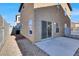 Backyard featuring a concrete patio, gravel landscaping, and a sliding glass door entry at 1203 Sweet Orange St, Las Vegas, NV 89142
