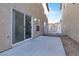 Concrete backyard patio featuring desert landscaping and access to the side yard at 1203 Sweet Orange St, Las Vegas, NV 89142