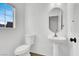 Clean half-bath with pedestal sink and toilet and natural lighting at 1203 Sweet Orange St, Las Vegas, NV 89142