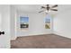 Bedroom with neutral carpet, ceiling fan, and natural light from two windows at 1203 Sweet Orange St, Las Vegas, NV 89142