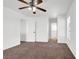 Bedroom featuring neutral carpet, ceiling fan, and multiple entryways at 1203 Sweet Orange St, Las Vegas, NV 89142