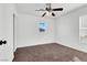 Bright bedroom featuring neutral carpet, a ceiling fan, and natural light from two windows at 1203 Sweet Orange St, Las Vegas, NV 89142