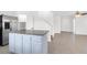 Open-concept kitchen with an island, stainless steel appliances, and tile flooring at 1203 Sweet Orange St, Las Vegas, NV 89142