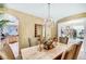 Elegant dining room with a crystal chandelier and open view of the kitchen at 1353 Volturno Way, Henderson, NV 89052